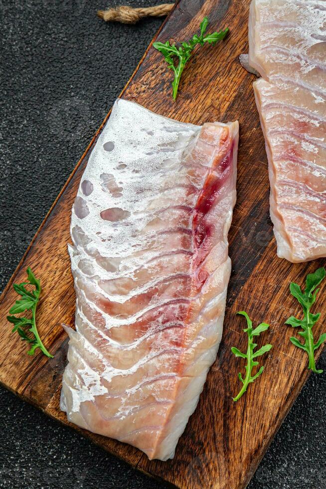 fillet of white fish without skin and bones fresh seafood healthy meal food snack on the table copy space food background rustic top view pescatarian diet photo