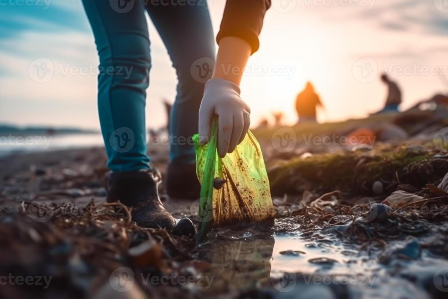 volunteer collects garbage on a muddy beach. The concept of Earth Day. Closeup. photo