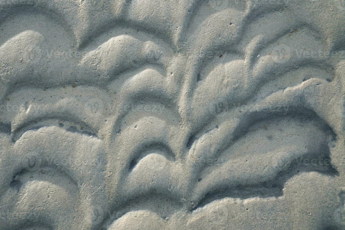 Structure in the sand made by waves. View on the ground at low tide. Nature photo