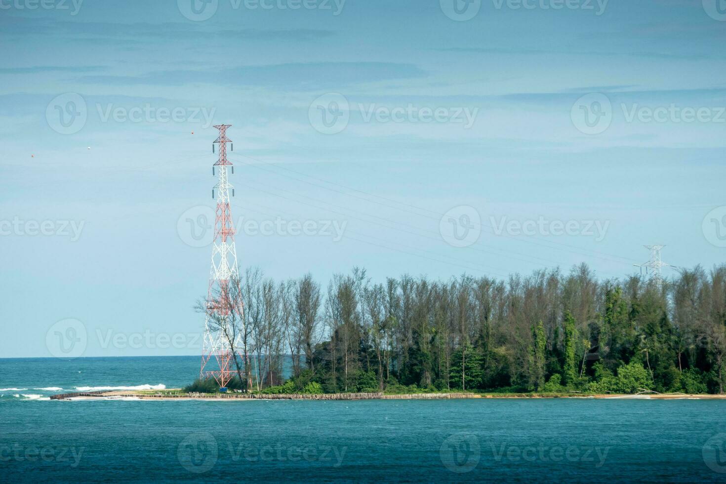 Island in the middle of the sea and electricity poles at Thailand. photo