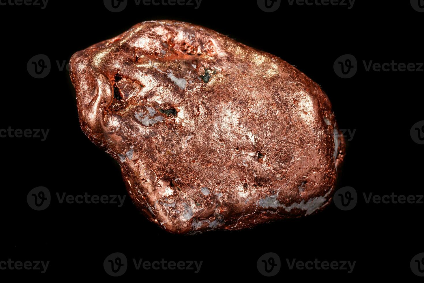 Macro mineral stone of a copper nugget on a microcline on a black background photo