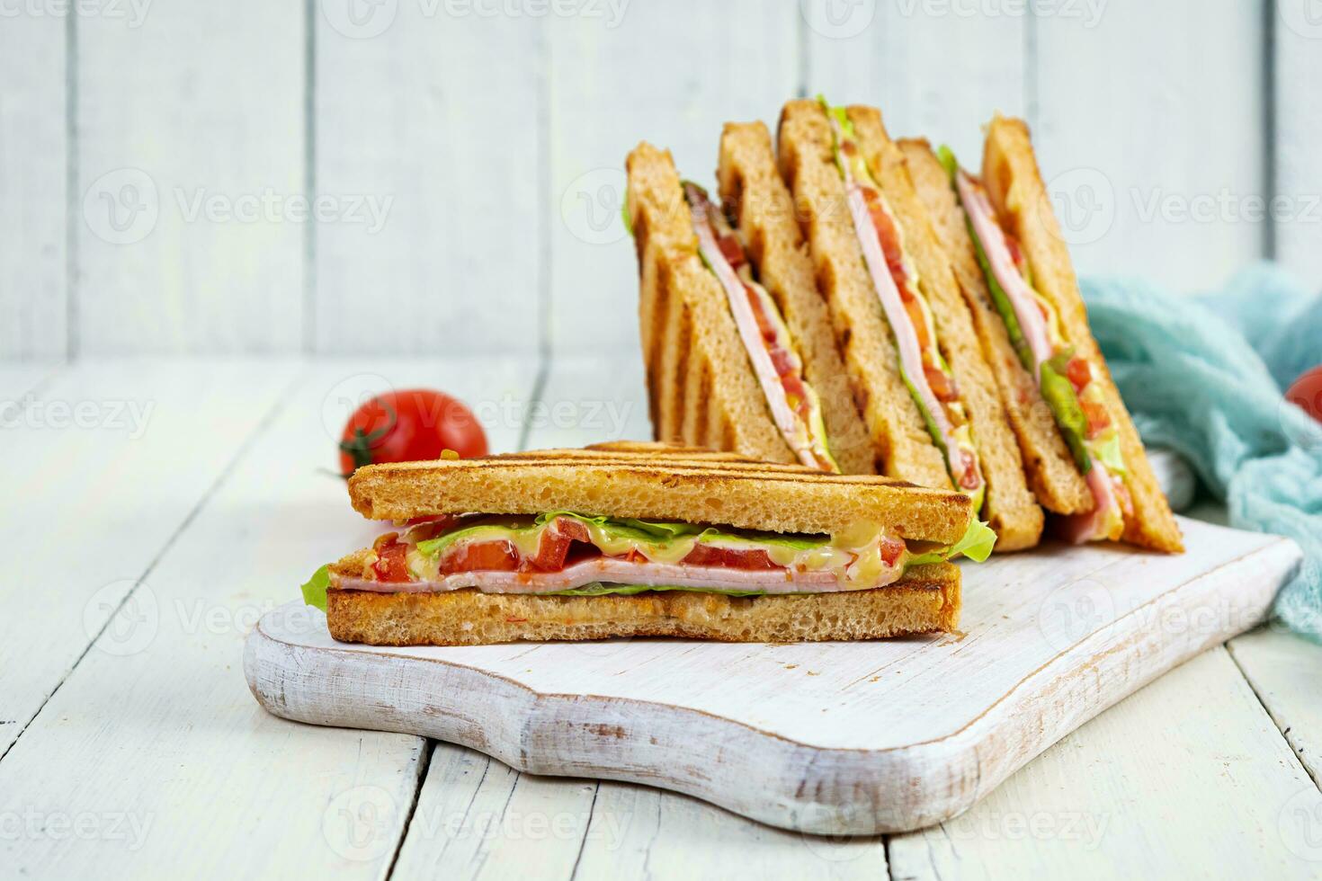 Club sandwich with ham, tomato, green and cheese. Grilled panini photo