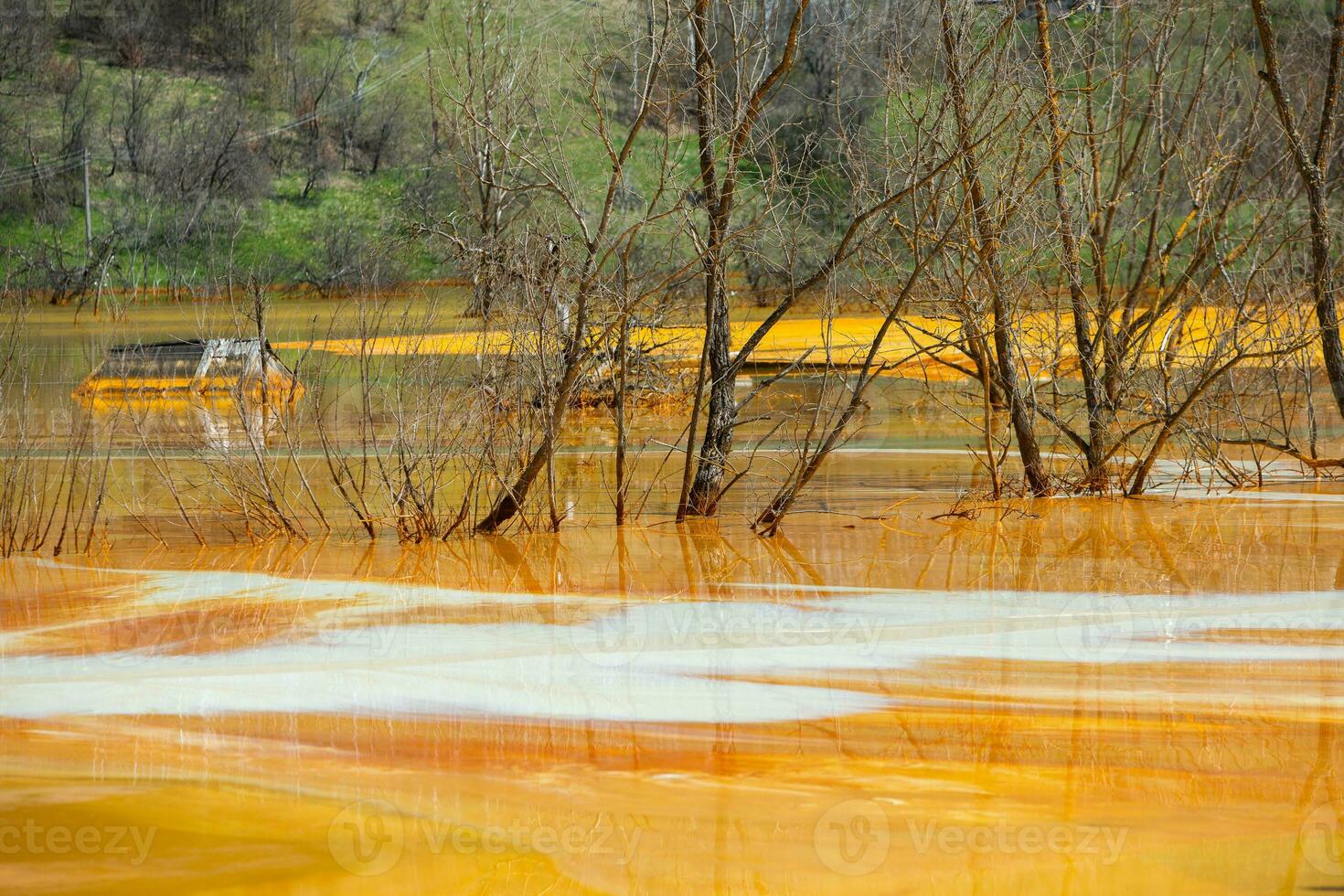 A lake contaminated with toxic waste in the western mountains of Romania. Nature pollution from copper mine. Ecological catastrophe or Environmental disaster photo