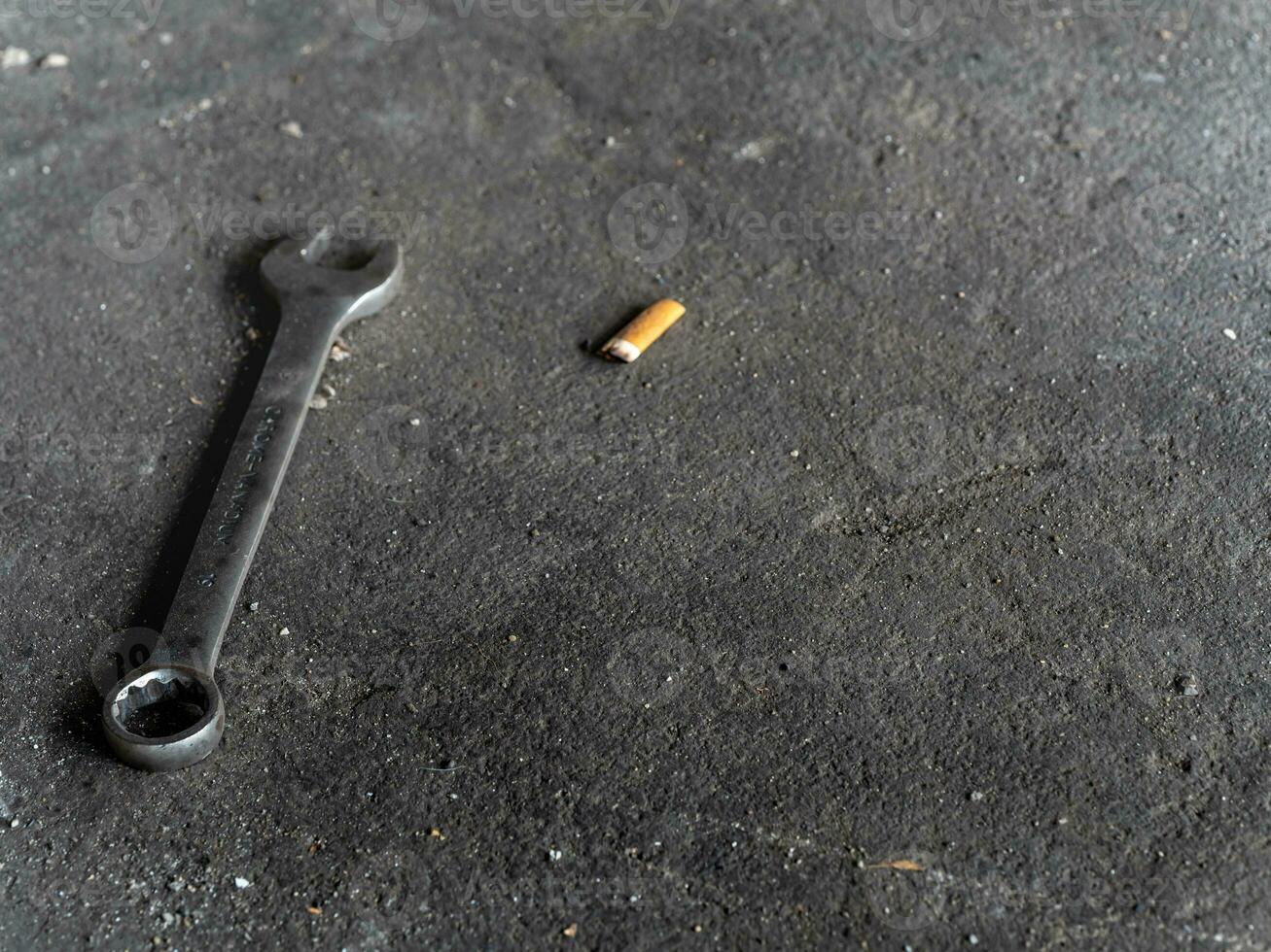 The Combination wrench on the rough concrete flooring photo