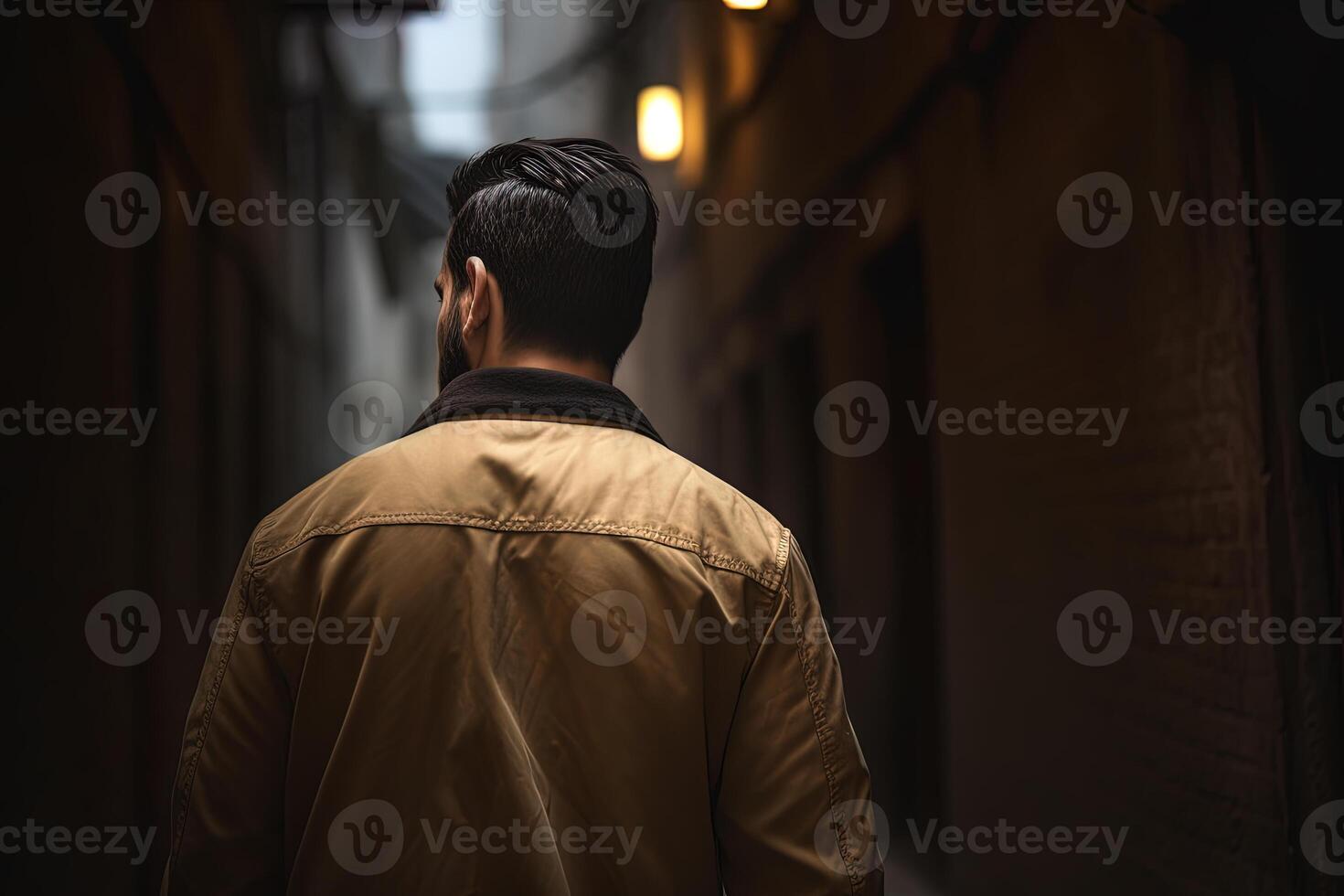 back view of a man walking down a narrow alleyway. photo