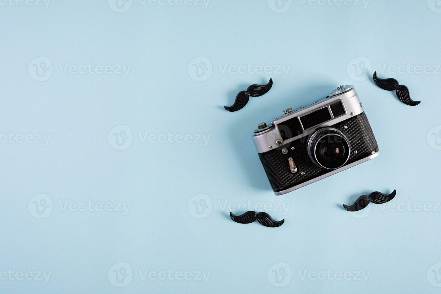 Curly mustaches on colorful background. Fake mustache. Top view photo