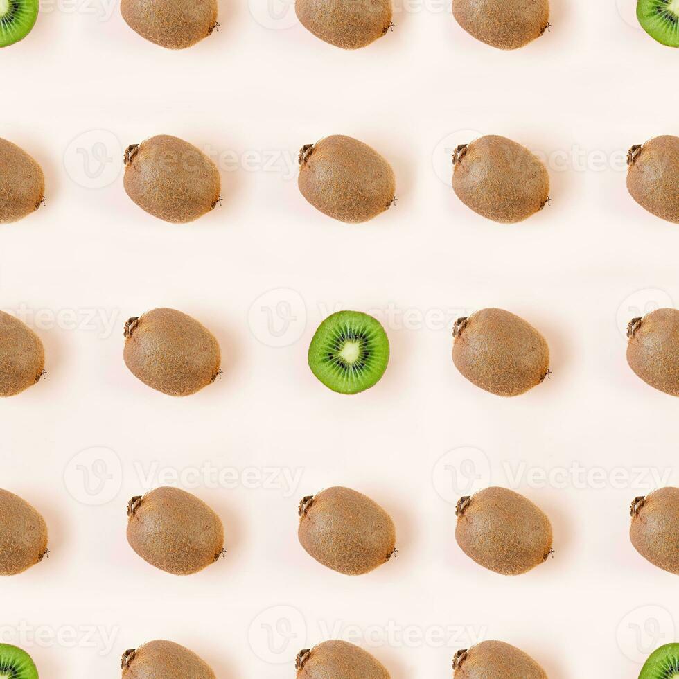 Kiwi fruit on wooden background. Pattern with juicy kiwifruit photo