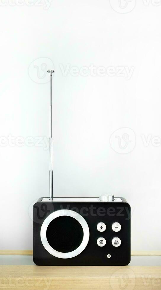 Vertical image, Retro style vintage transistor radio receiver, nostalgia, tuning function with AM and FM frequency station, on wooden counter and white background photo