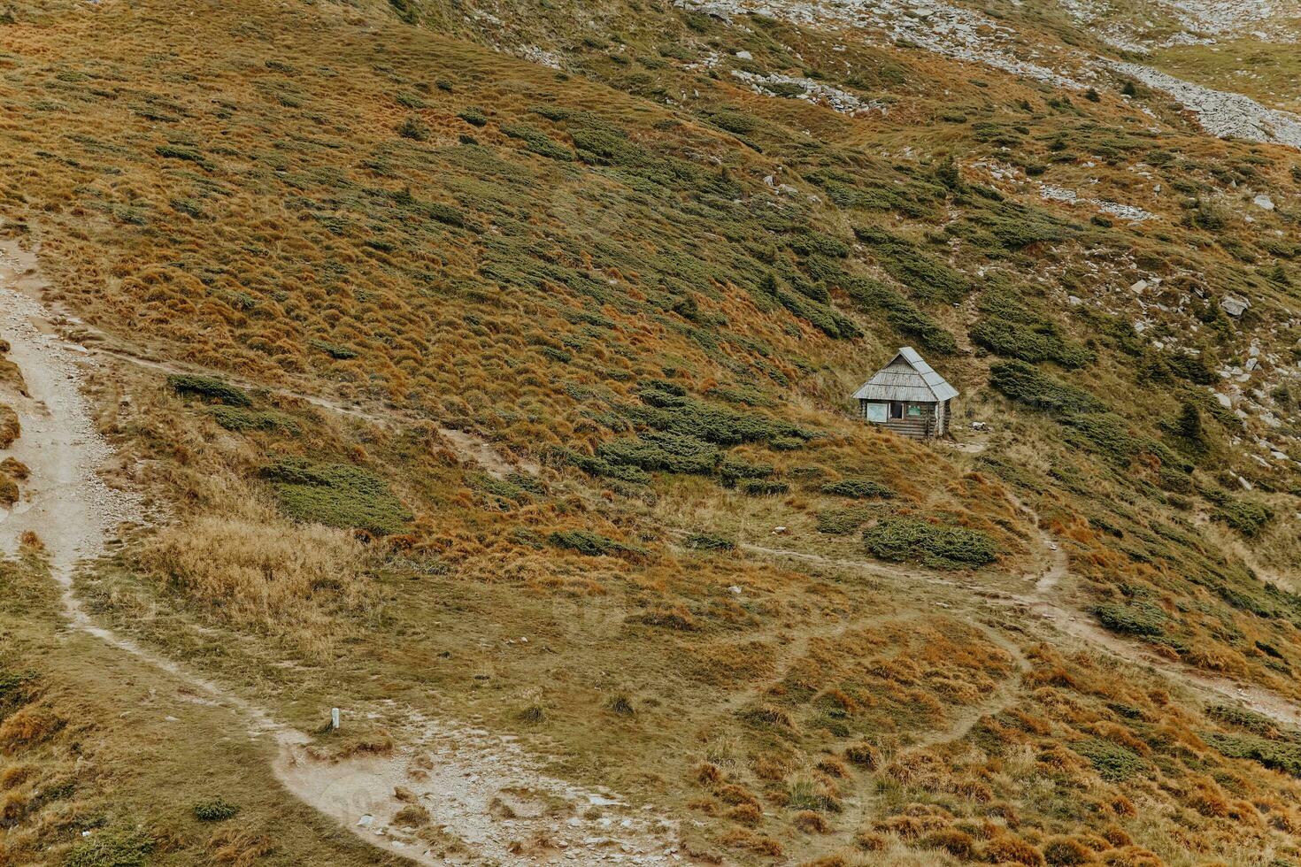 the field in the mountains is strewn with stones photo