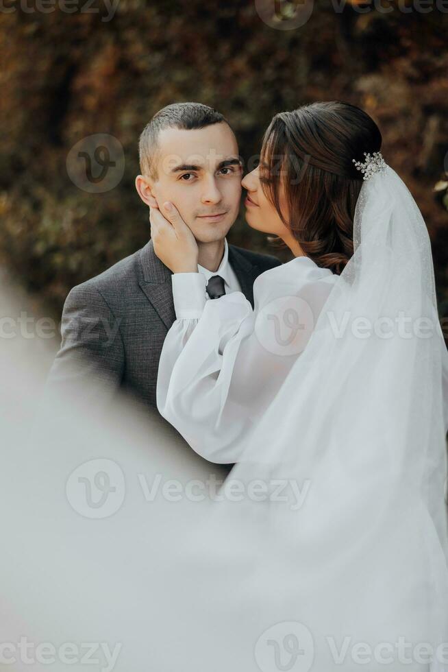 Bride and groom having a romantic moment on their wedding day. beautiful veil, romantic bride. Elegant groom. photo