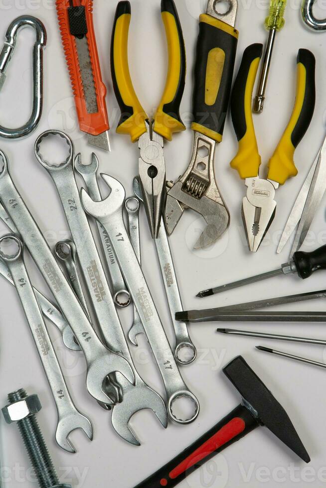 Set of tools for construction or the house. Wrench, pliers, hammer, screwdriver, flashlight, bold, scissors, knife and others. photo
