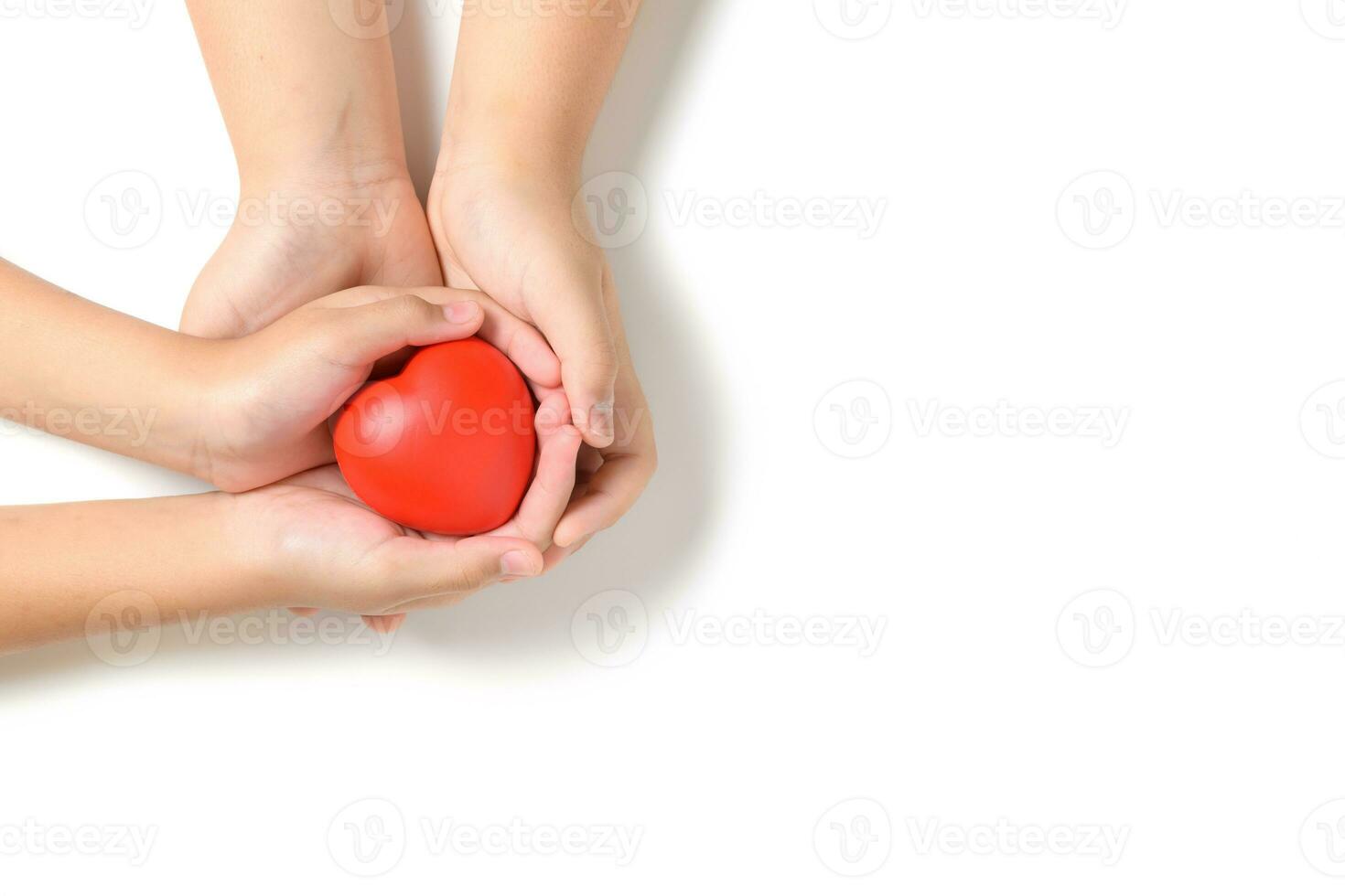 Hand child holding red heart isolated on white background photo