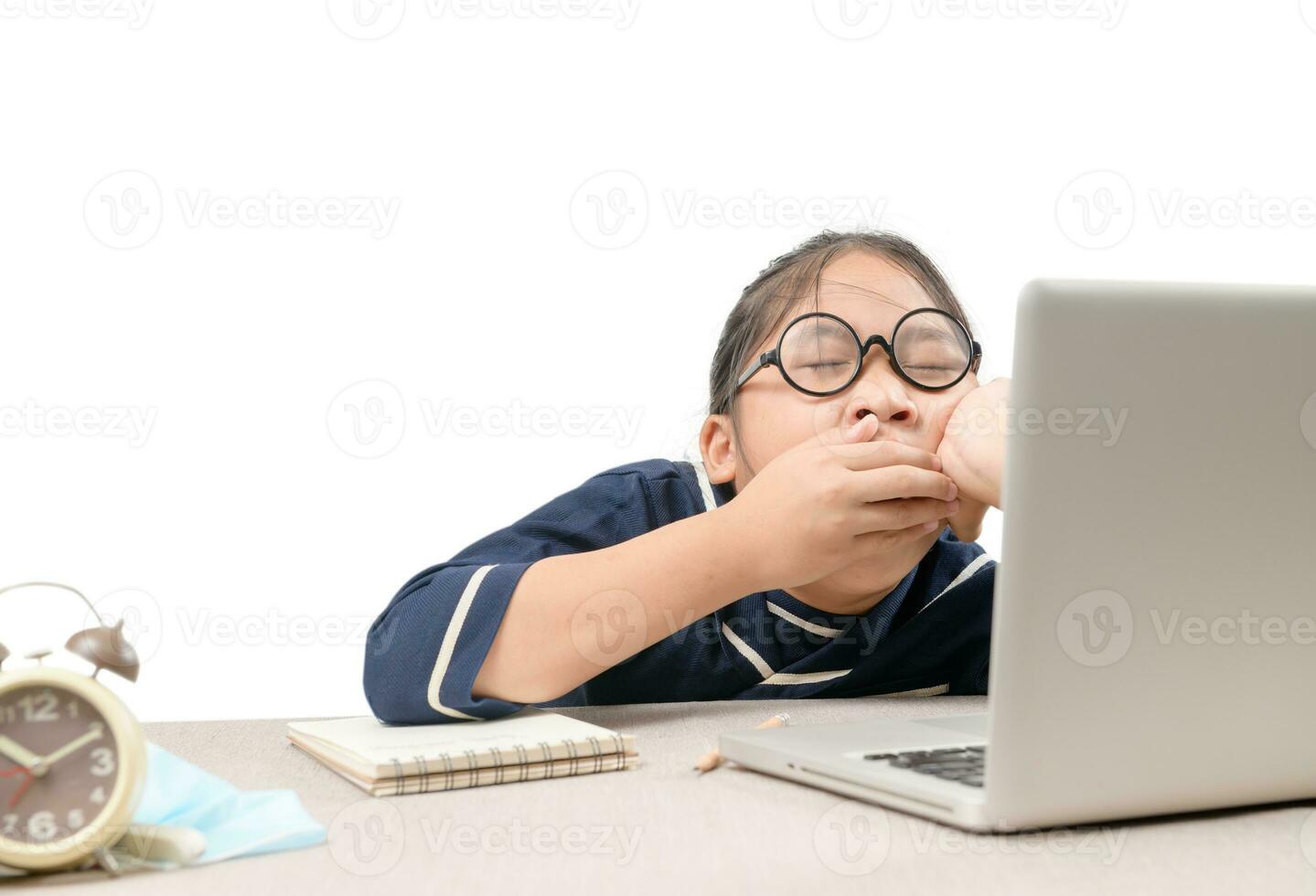 Girl student is yawning and bored while studying online. Due to the outbreak of COVID 19 photo