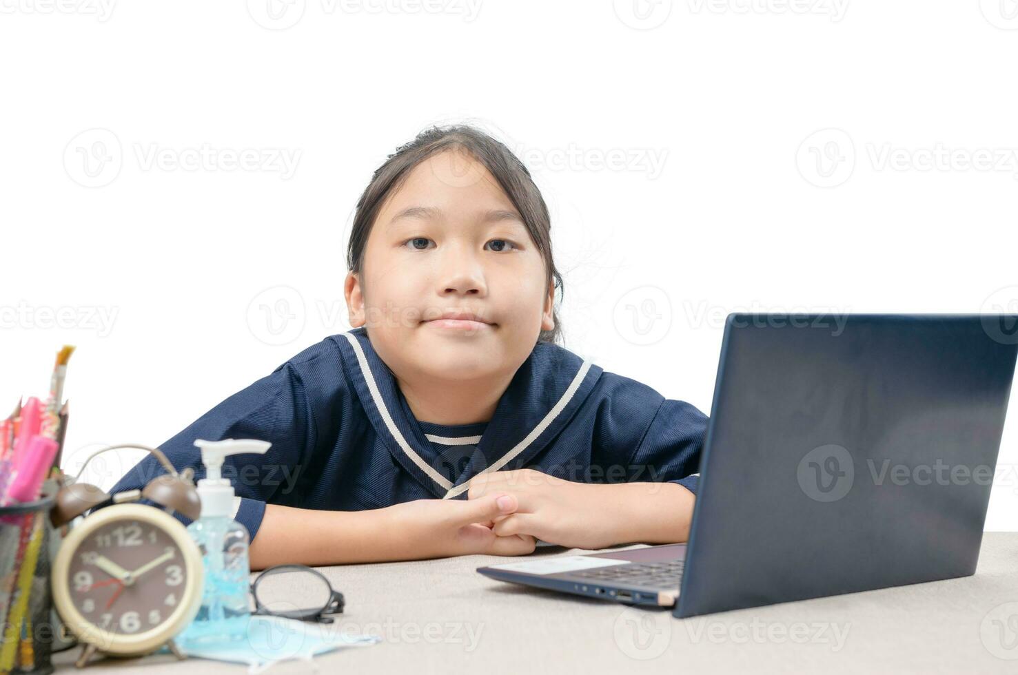 Happy cute girl watching videos streaming online on her laptop at home isolated on white. photo