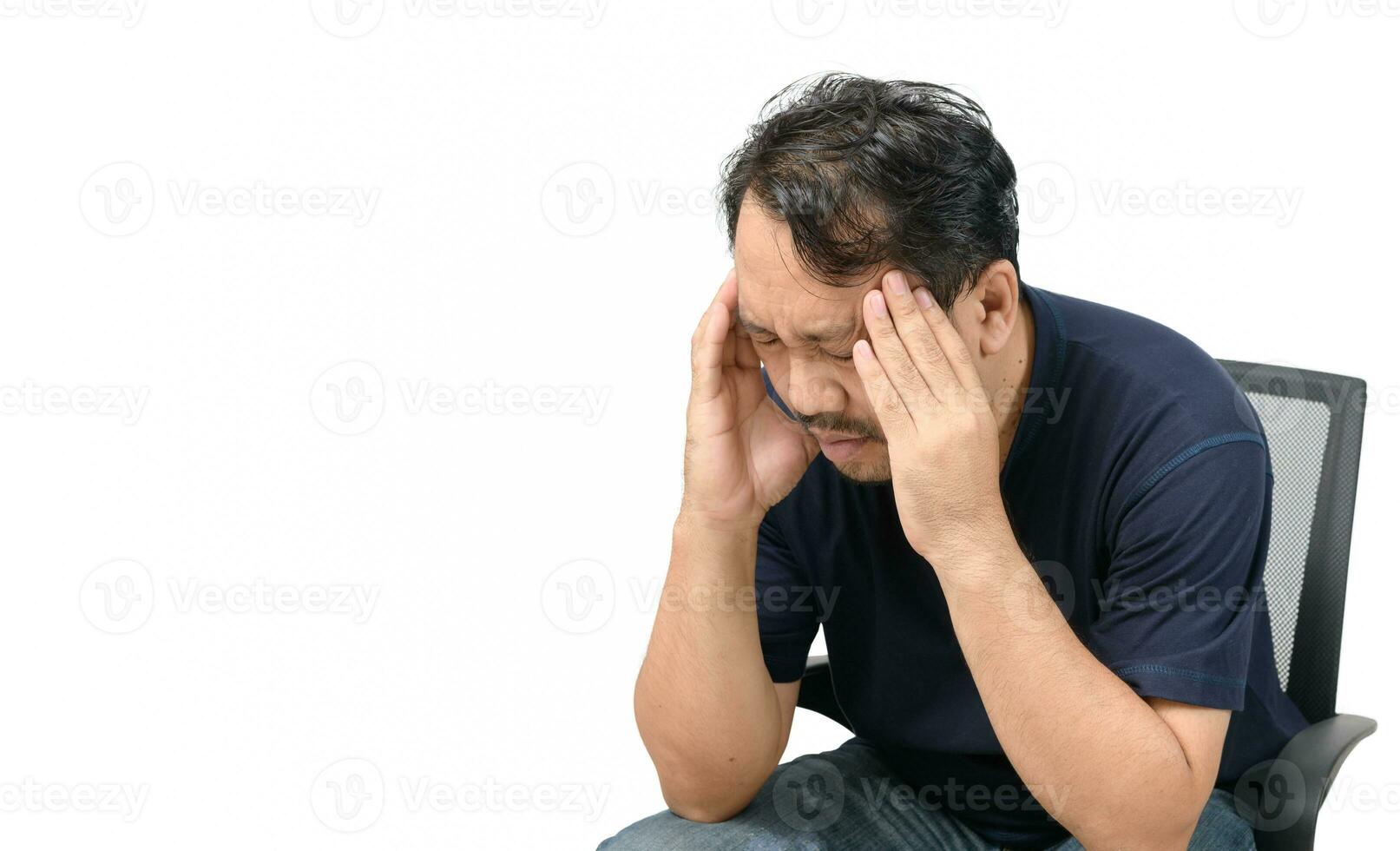 Middle-aged man sitting on chair and feeling stressed and headache isolated photo