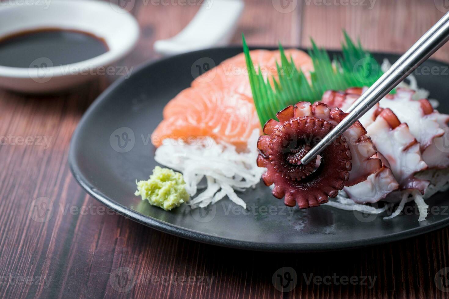 Tako sashimi on  chopsticks, Japanese food photo