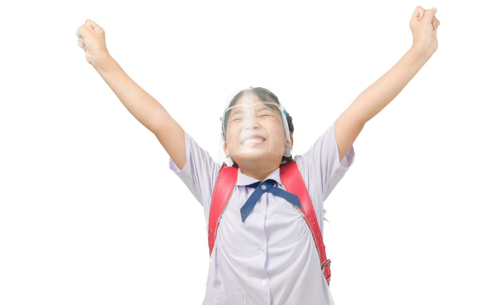 Cute girl student wearing face shield and raising hands isolated photo