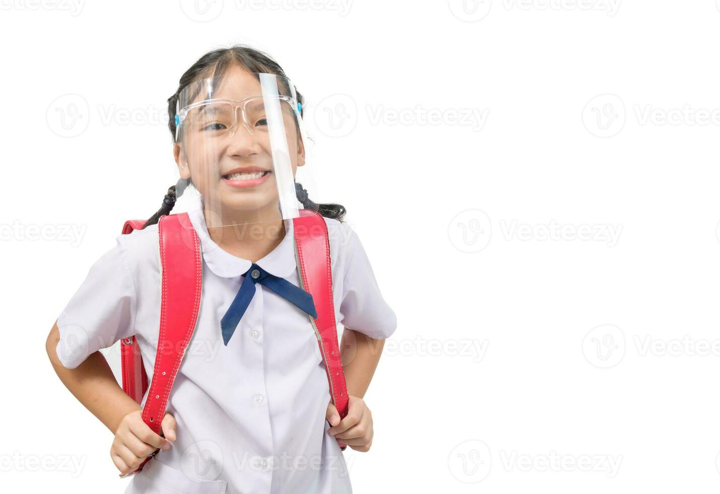 Cute girl student wearing face shield and carries school bag isolated on white photo