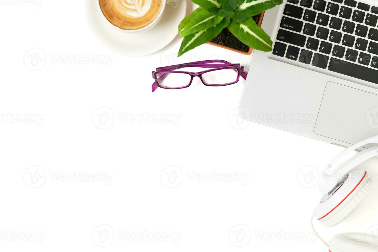 White office desk table with laptop computer, Latte art hot coffee and eye glasses. photo