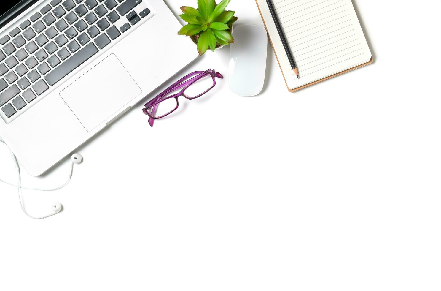 White office desk table with laptop computer and blank notebook isolated photo