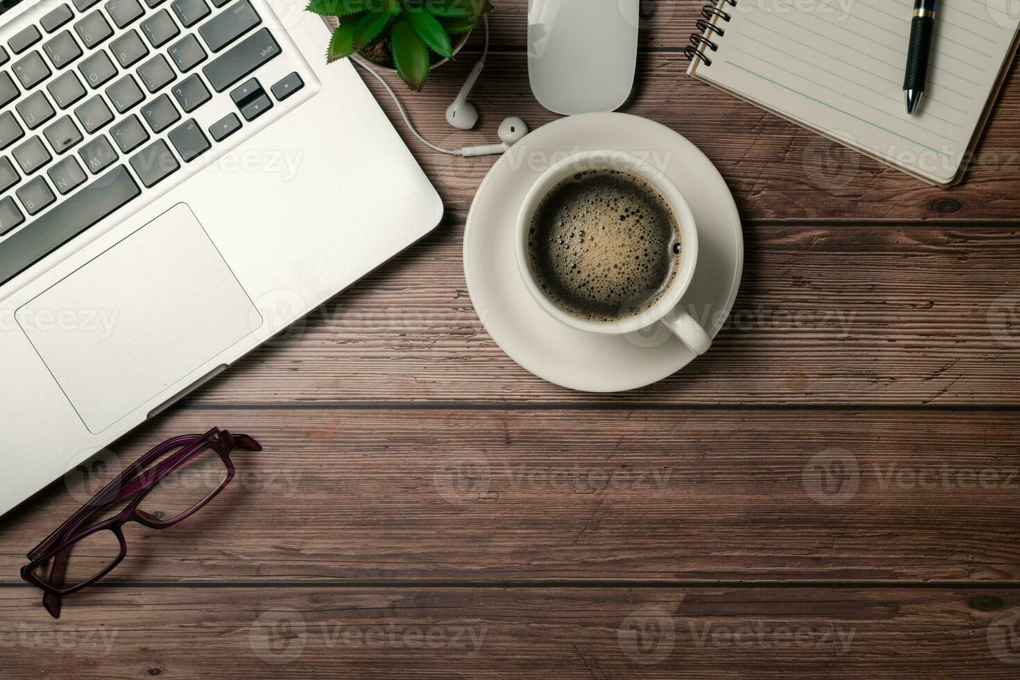 Old wood desk table with black coffee  and laptop computer photo