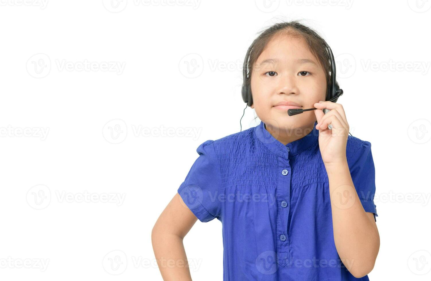 Cute asian girl is working as an operator at helpline talking with customer using headset, photo