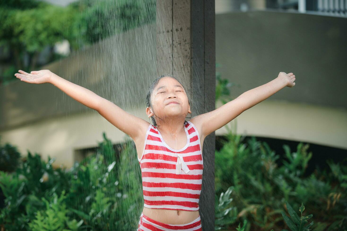 Happy cute girl taking shower before swimming, 25285504 Stock Photo at