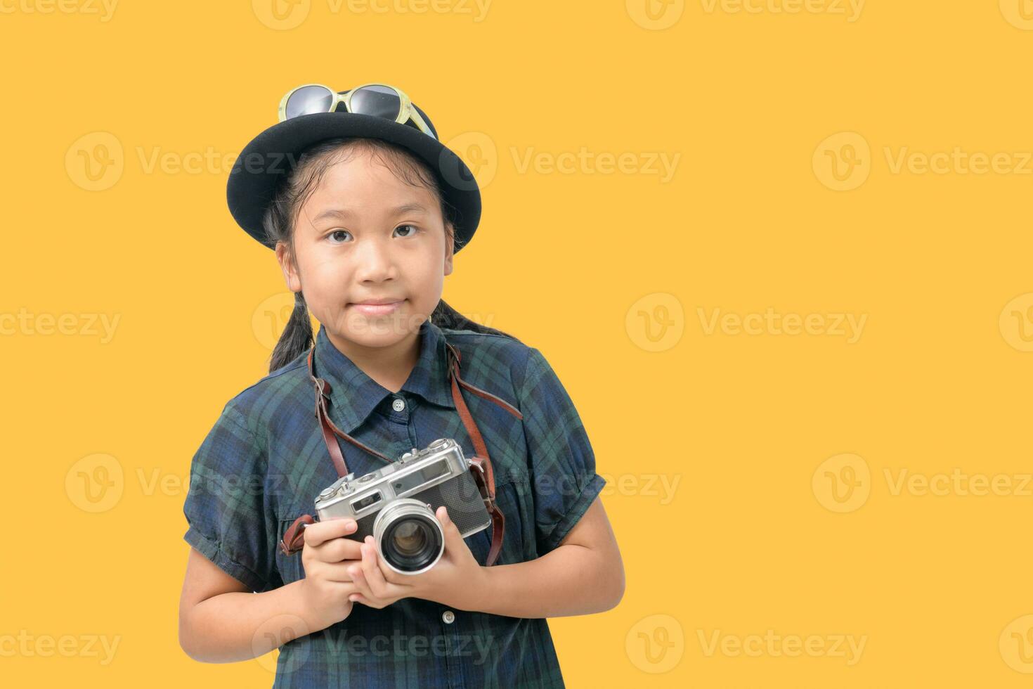 Cute little asian girl with sunglasses and holding vintage camera isolated photo