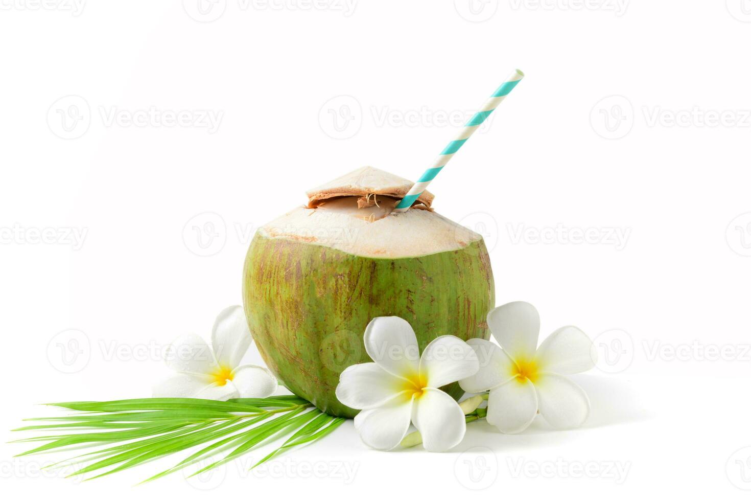 Fresh coconut drink with plumeria flower and paper straw photo