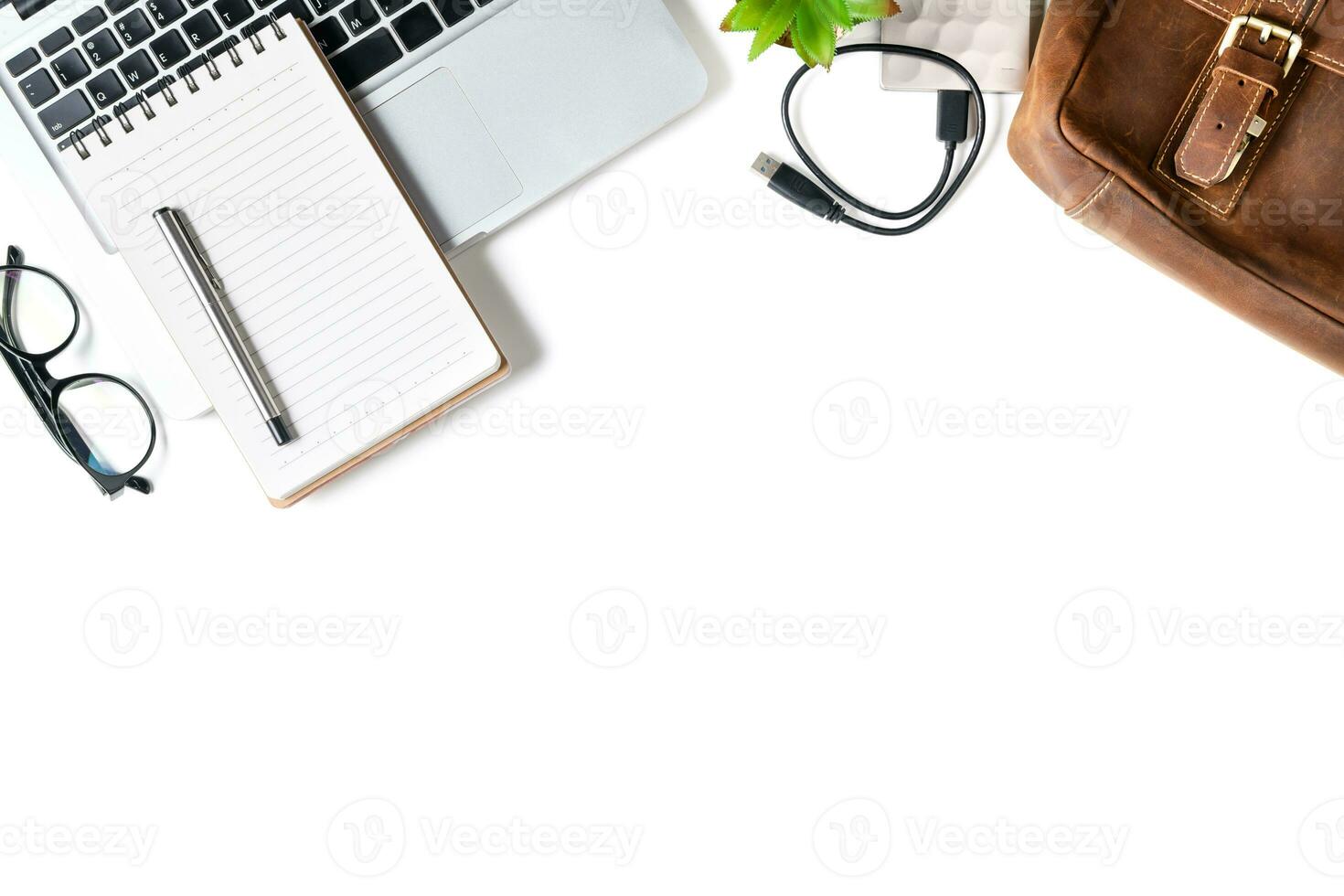 White office desk table with laptop computer, blank notebook photo