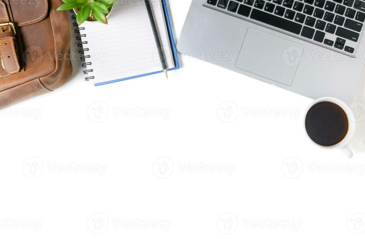 White office desk table with laptop computer, blank notebook photo
