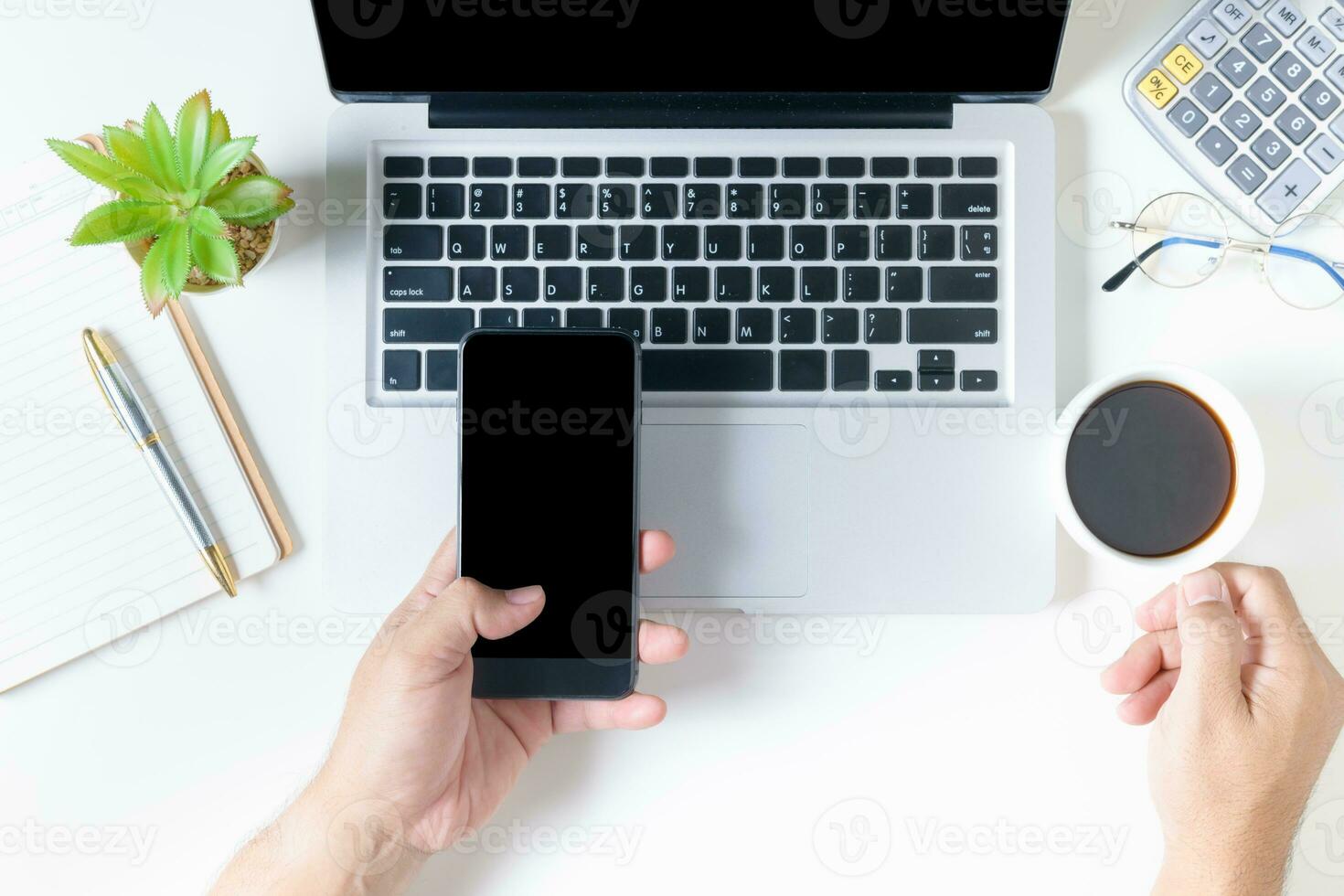 Business man holding smart phone and hot coffee photo