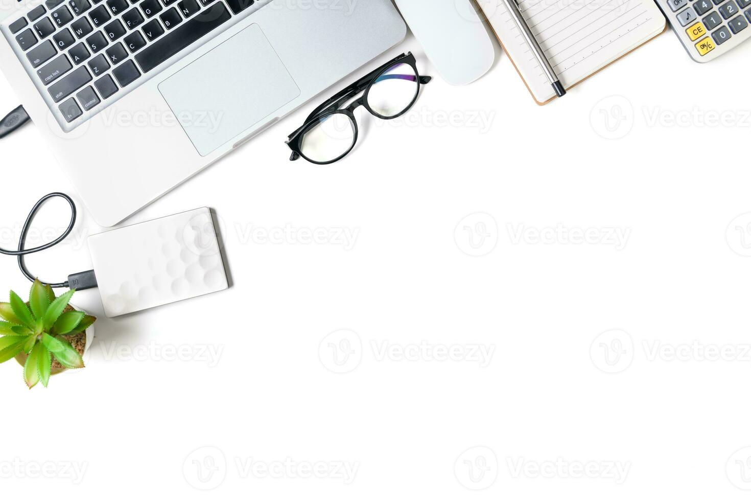 White office desk table with laptop computer and blank notebook. photo