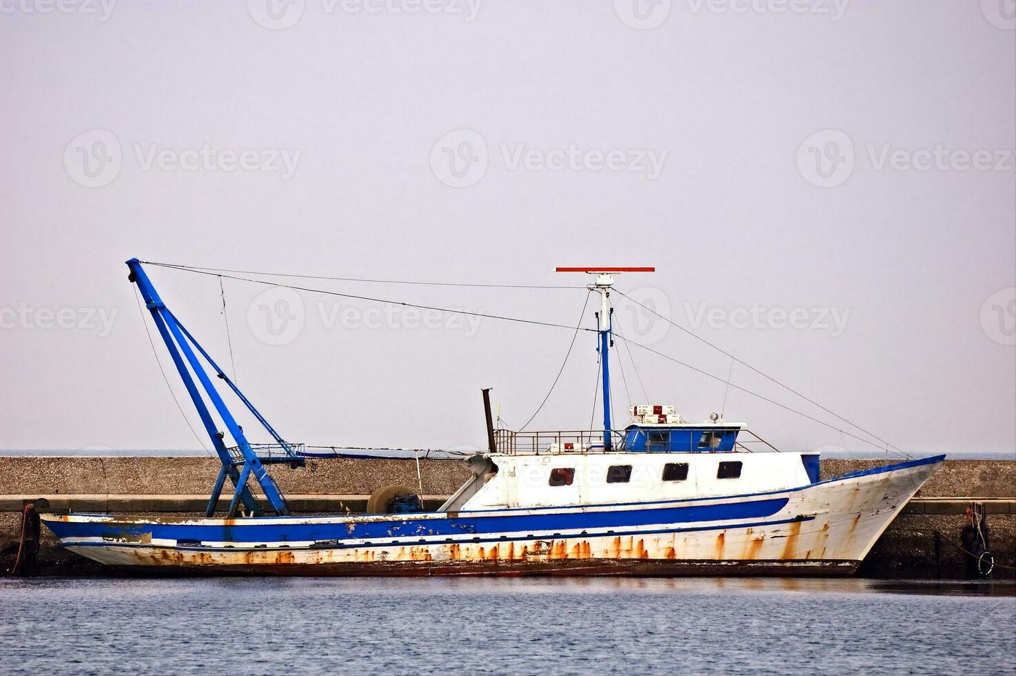 Moored fishing boat photo