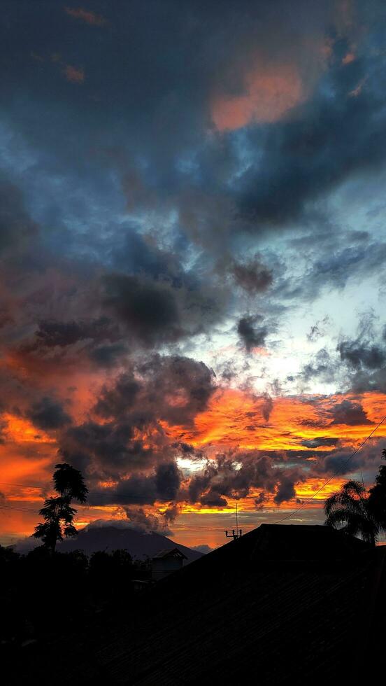 A sunset with a house in the background photo