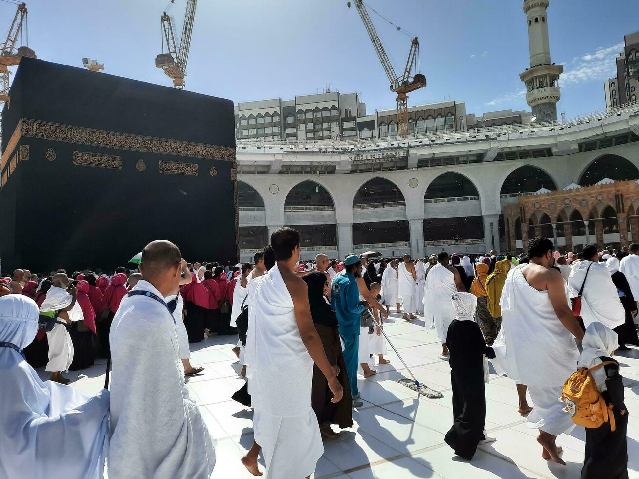 Mecca, Saudi Arabia, April 2023 - Pilgrims from different countries of the world are performing Tawaf in the courtyard of Masjid al-Haram in Mecca during the day. photo