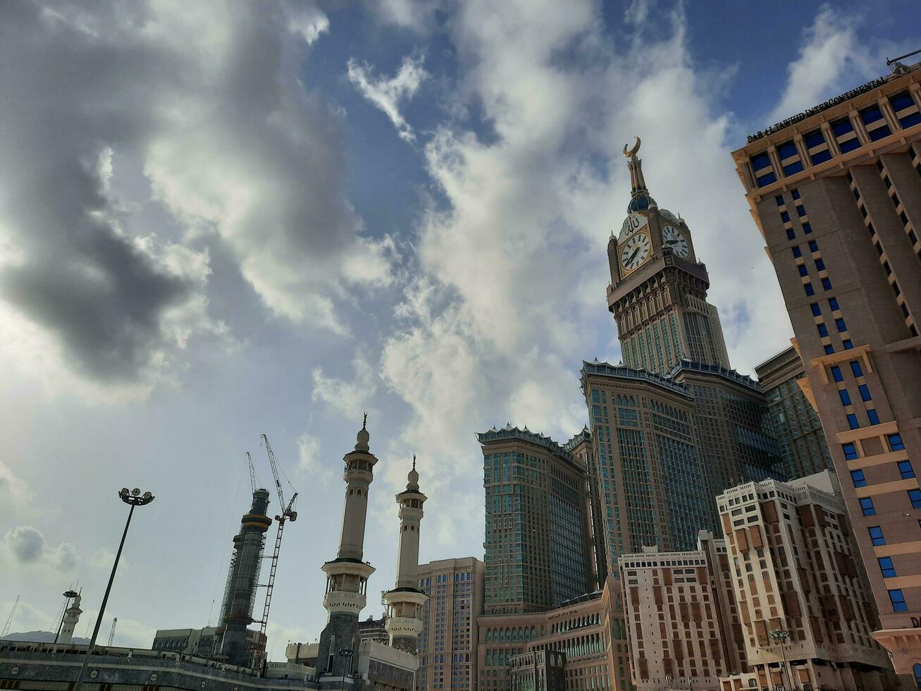 Mecca, Saudi Arabia, April 2023 - A beautiful daytime view of the Makkah Clock Tower from the courtyard of Masjid al-Haram, Mecca. photo