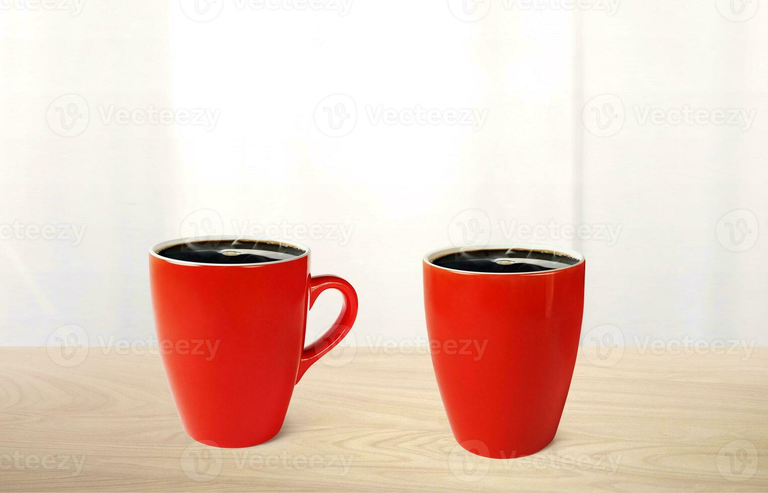 Hot coffee in red mug on wooden table There is a white mirror in the background. photo