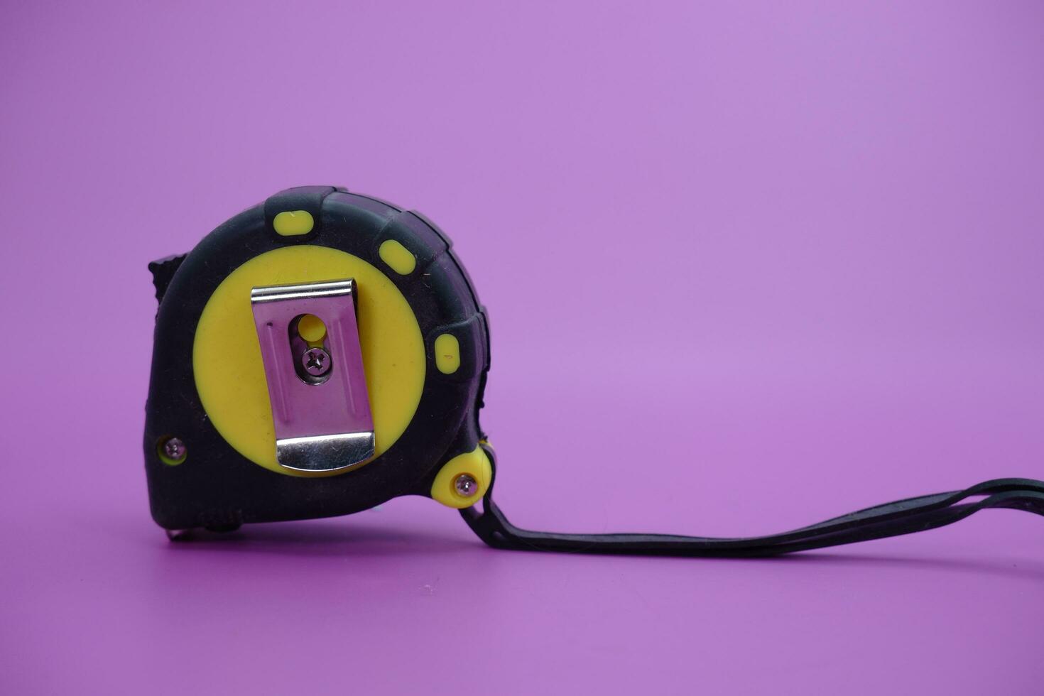 tape measure isolated purple background. measuring tool used by builders. photo