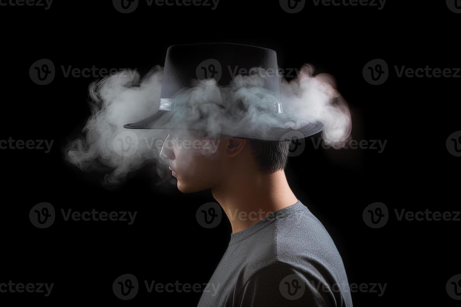 Smoke enveloped a man wearing a hat. Portrait of stylish man with smoke on dark background. photo