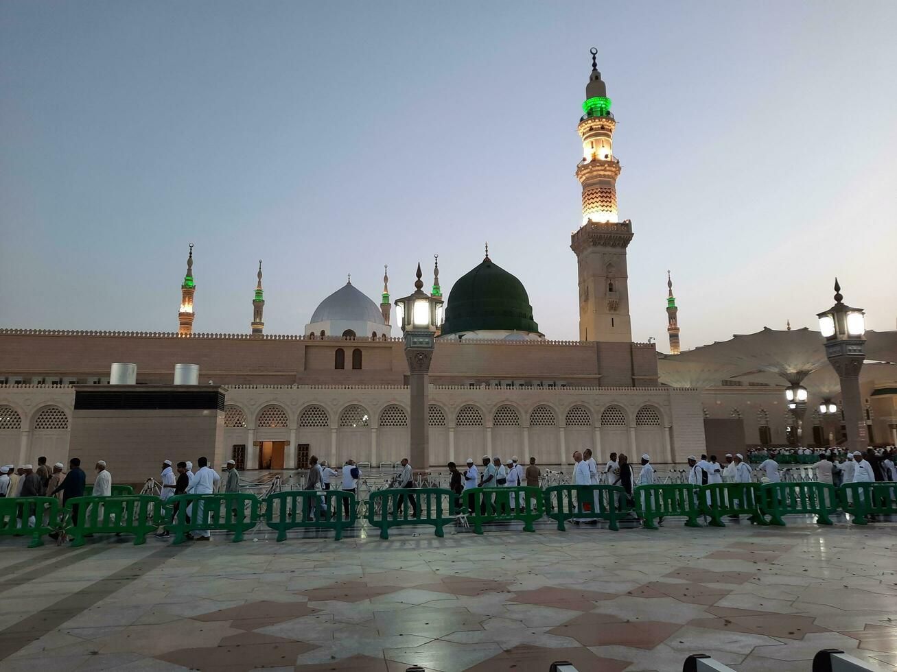 Medina, Saudi Arabia, May 2023 - Beautiful morning view of Masjid Al Nabawi, Medina. Visitors, courtyards outside the mosque, beautiful lights,  and electronic umbrellas can also be seen. photo