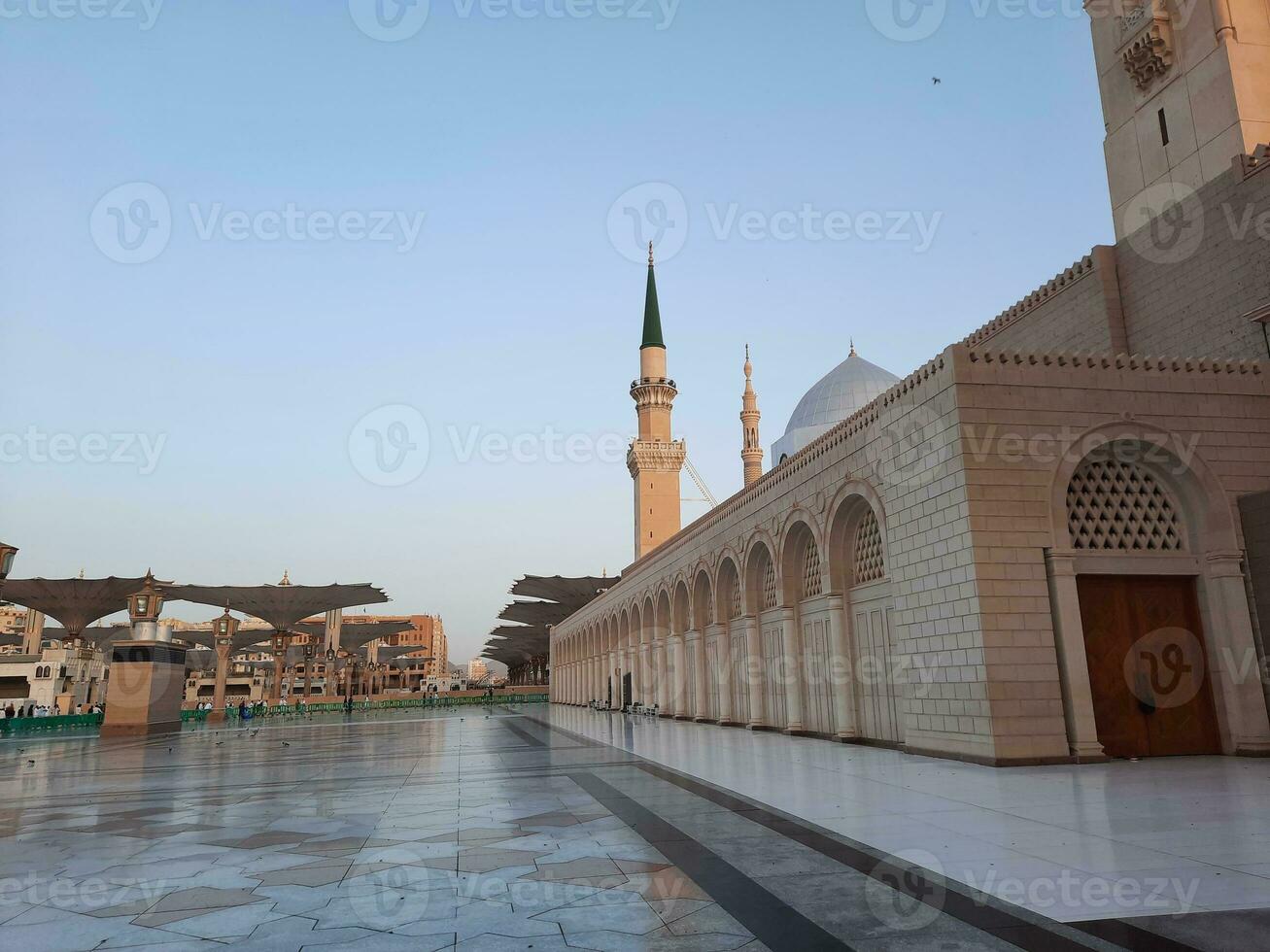 Beautiful daytime view of Masjid Al Nabawi, Medina's minarets and mosque courtyard. photo