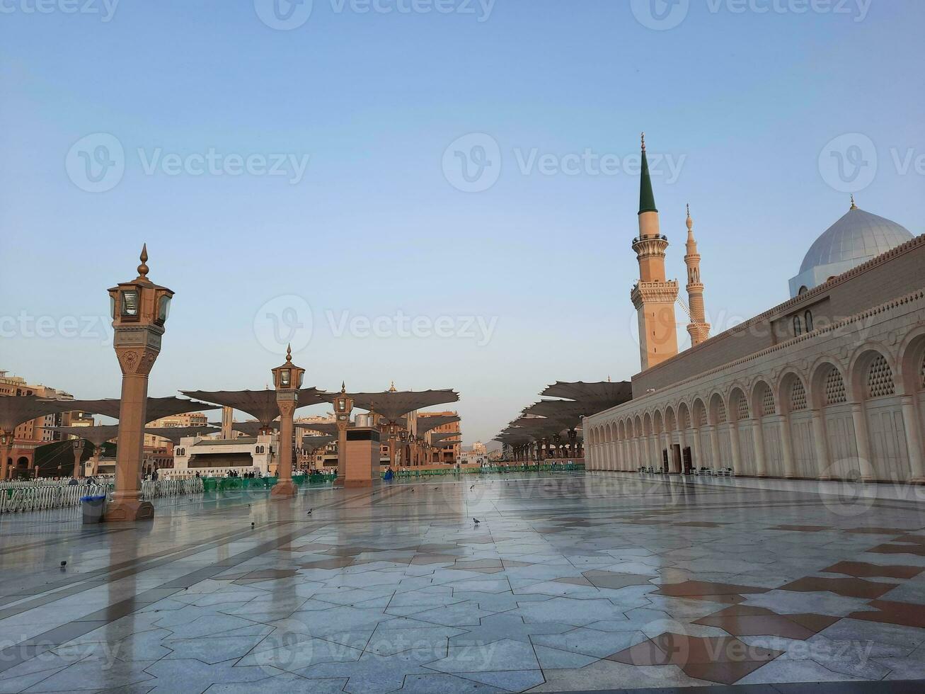 Beautiful daytime view of Masjid Al Nabawi, Medina's minarets and mosque courtyard. photo