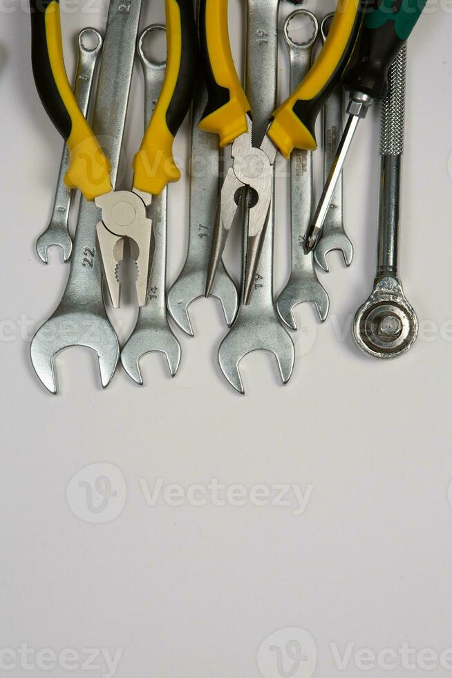 Set of tools for repair in a case on a white background. Assorted work or construction tools. Wrenches, Pliers, screwdriver. Top view photo