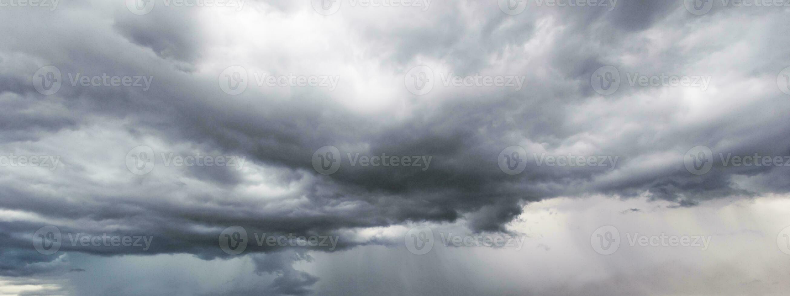 The dark sky with heavy clouds converging and a violent storm before the rain.Bad or moody weather sky and environment. carbon dioxide emissions, greenhouse effect, global warming, climate change photo
