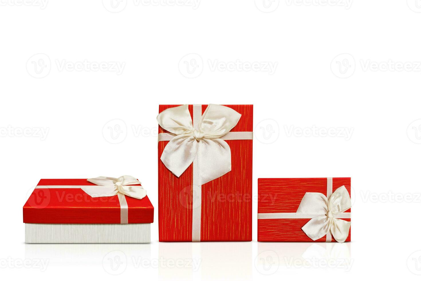 Red and white gift box with white ribbon isolated on white background photo