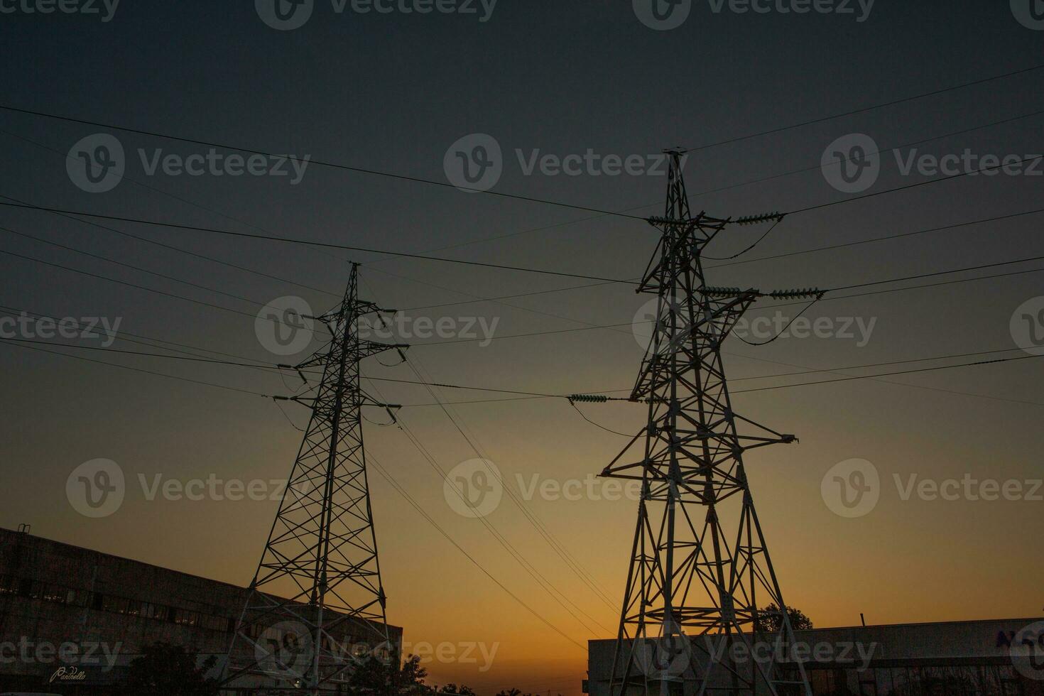 High-voltage power lines at sunset. Electricity distribution station.  electricity pylons on the background of the sky photo