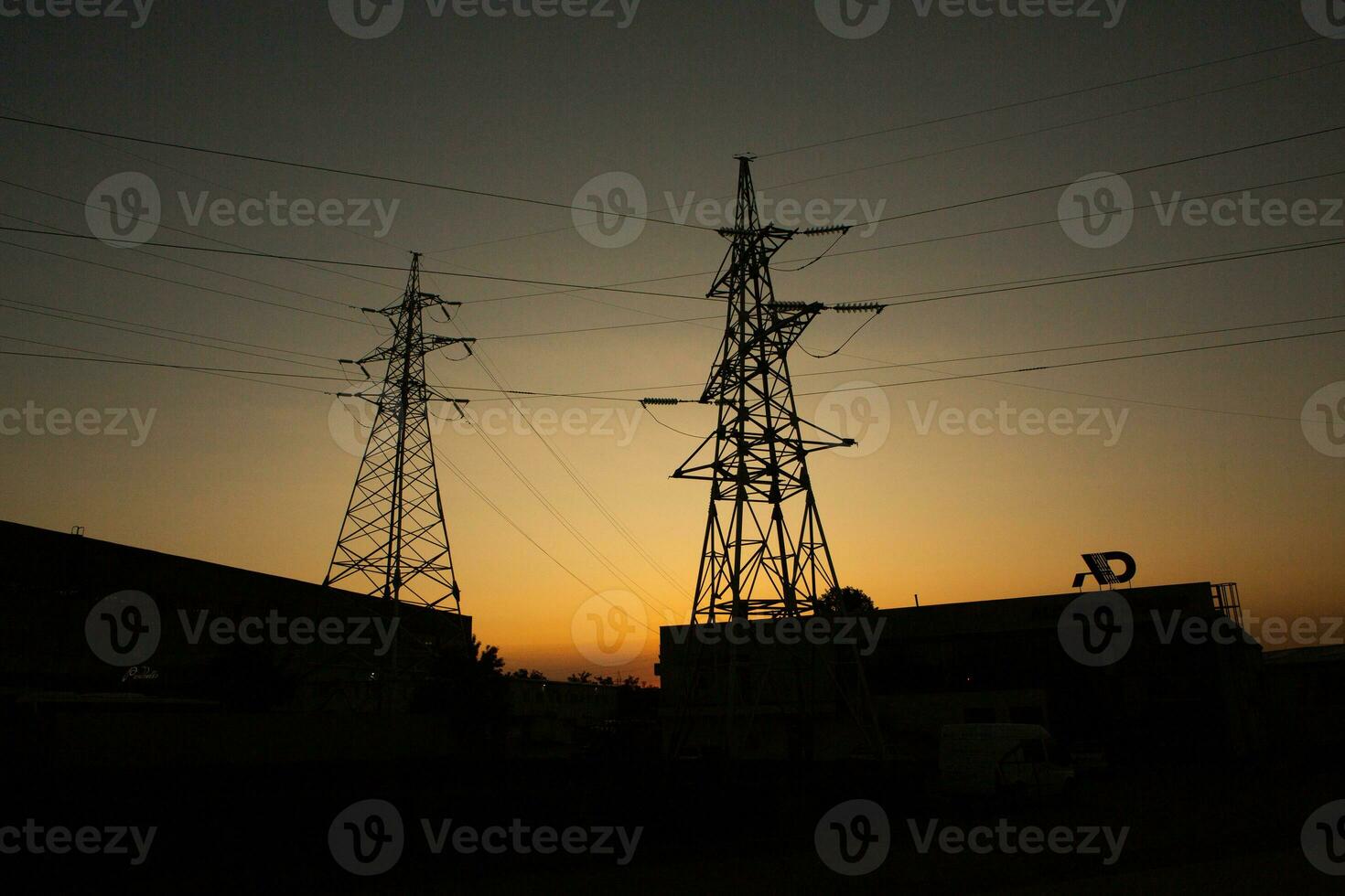High-voltage power lines at sunset. Electricity distribution station.  electricity pylons on the background of the sky photo