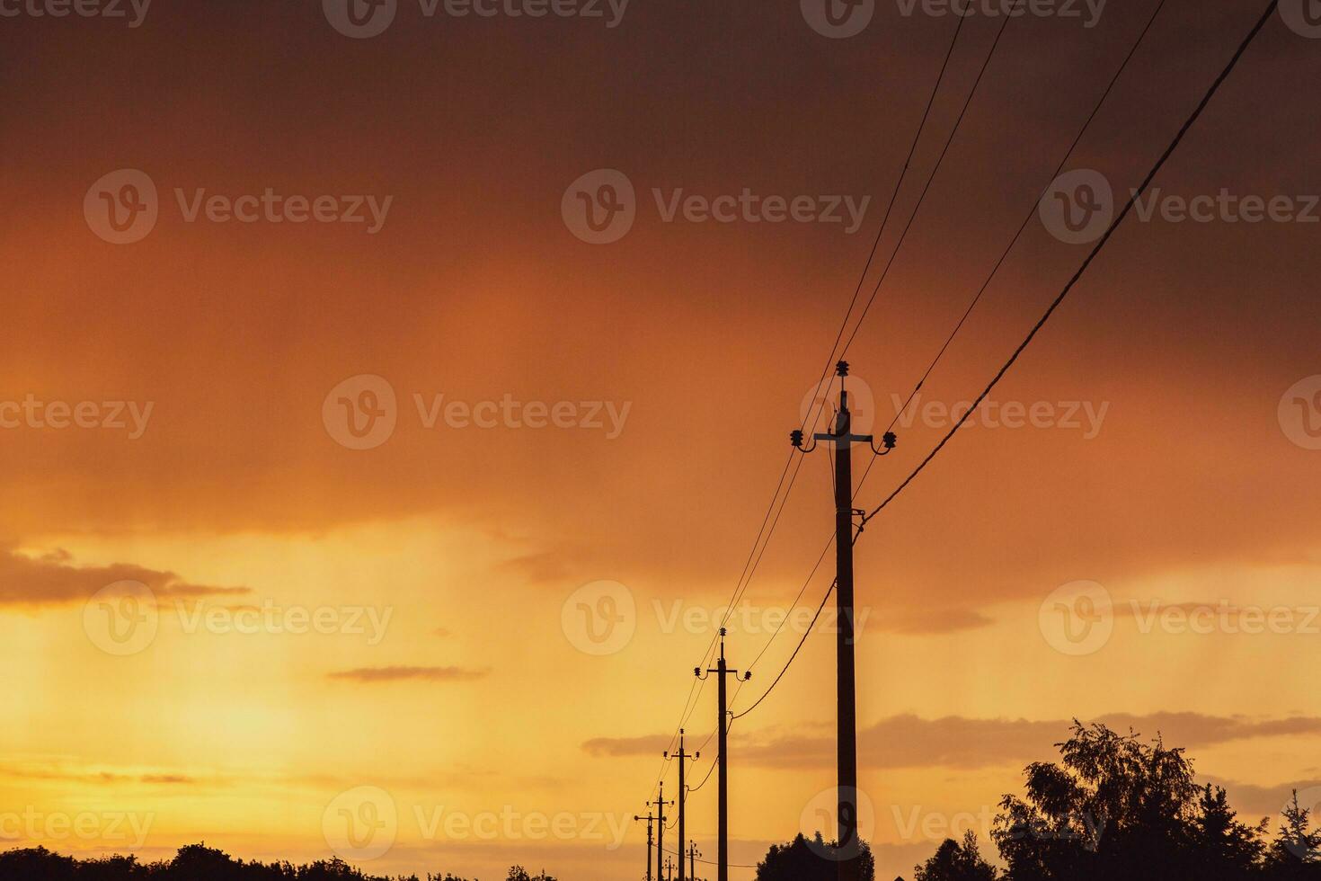 High-voltage power lines at sunset. Electricity distribution station.  electricity pylons on the background of the sky photo