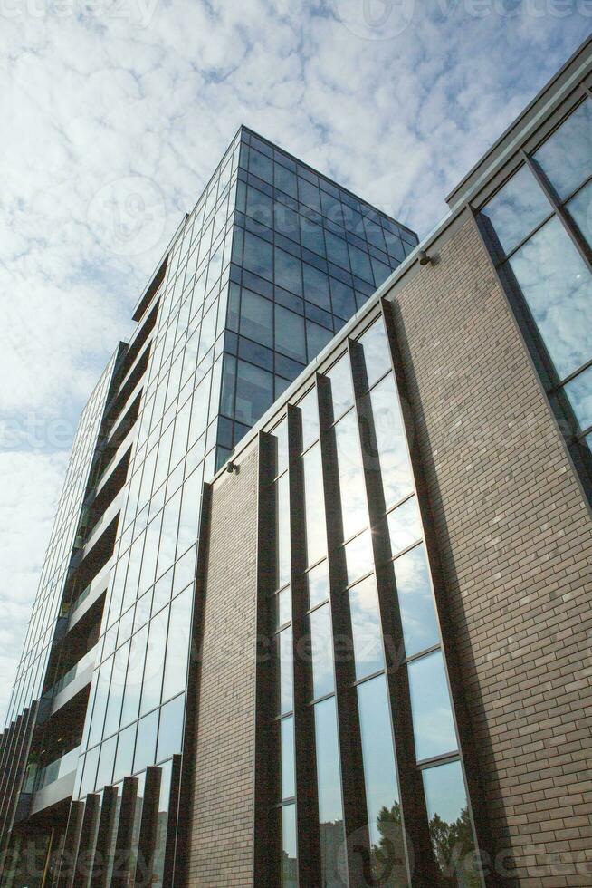 Modern office building with glass facade and blue sky. Business background. modern architecture in the city photo